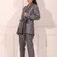 Trendy two piece pant suit women in blue and gray geometric pattern with a belted jacket and fitted pants