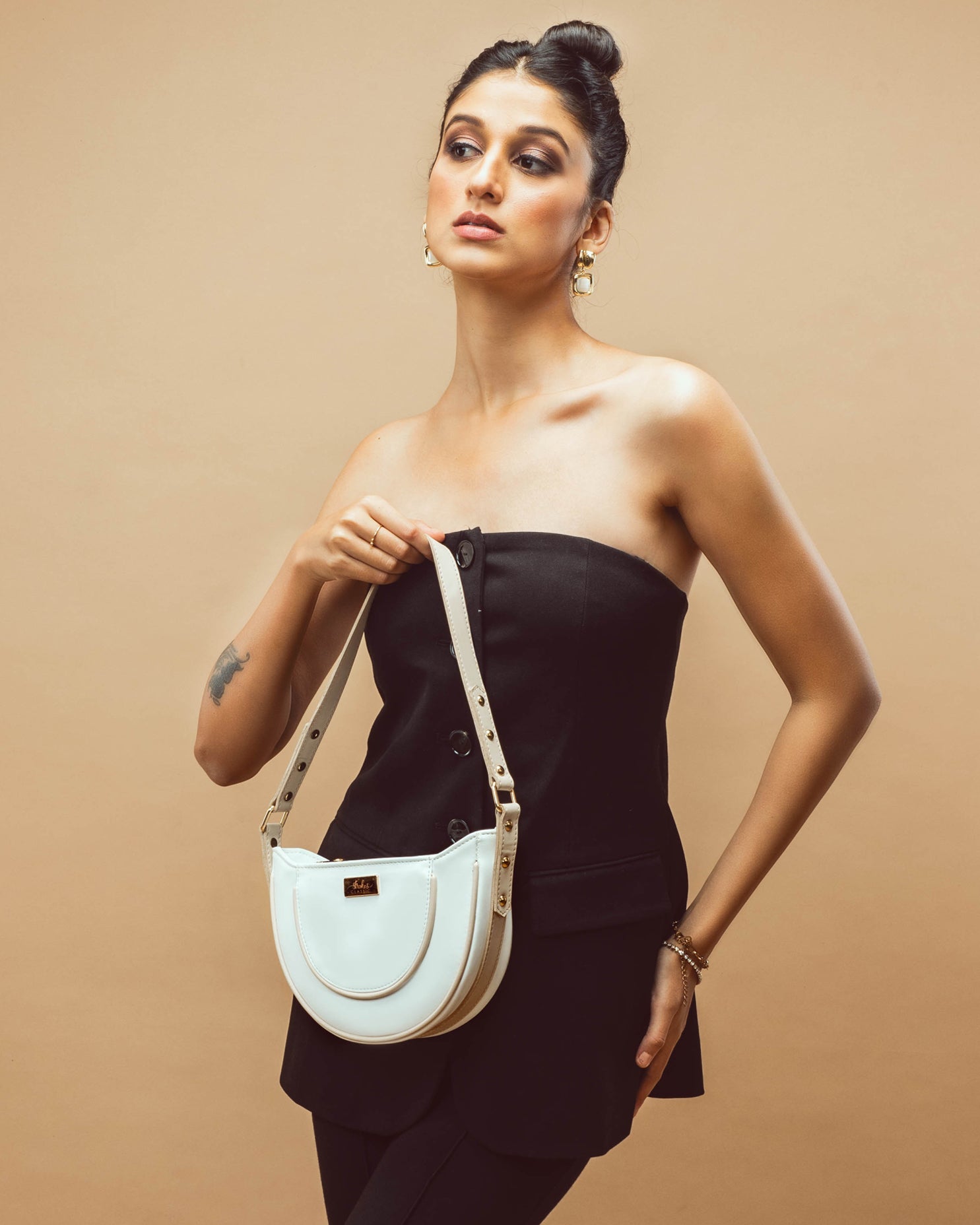Trendy white leather purse showcased on a model wearing a black outfit, ideal for stylish outings