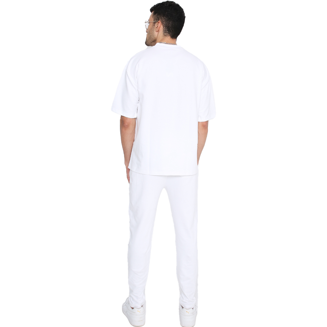 Rear view of male model wearing trendy white sweatpants by Stylera with relaxed fit and sneakers