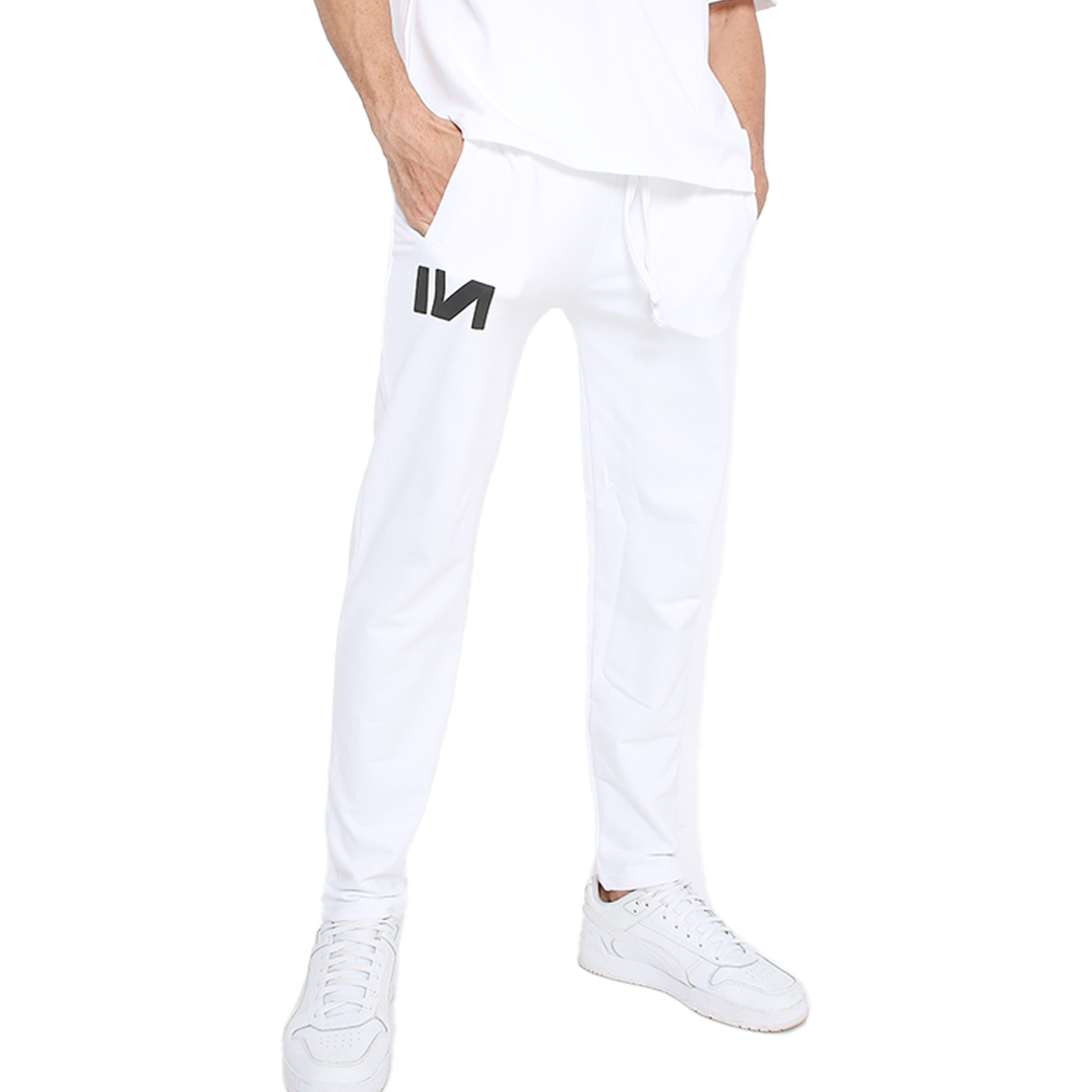 Stylera trendy white sweatpants with tapered leg drawstring waist and side pockets on male model