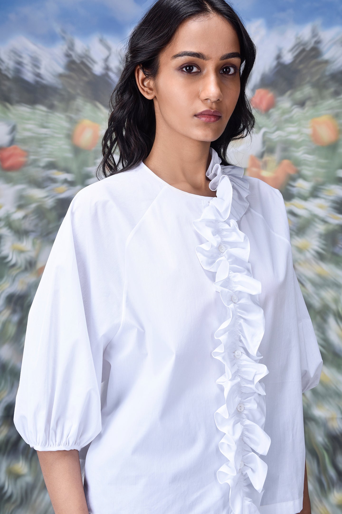 Stylera white ruffle front top with puff sleeves on model trendy white tops for ladies