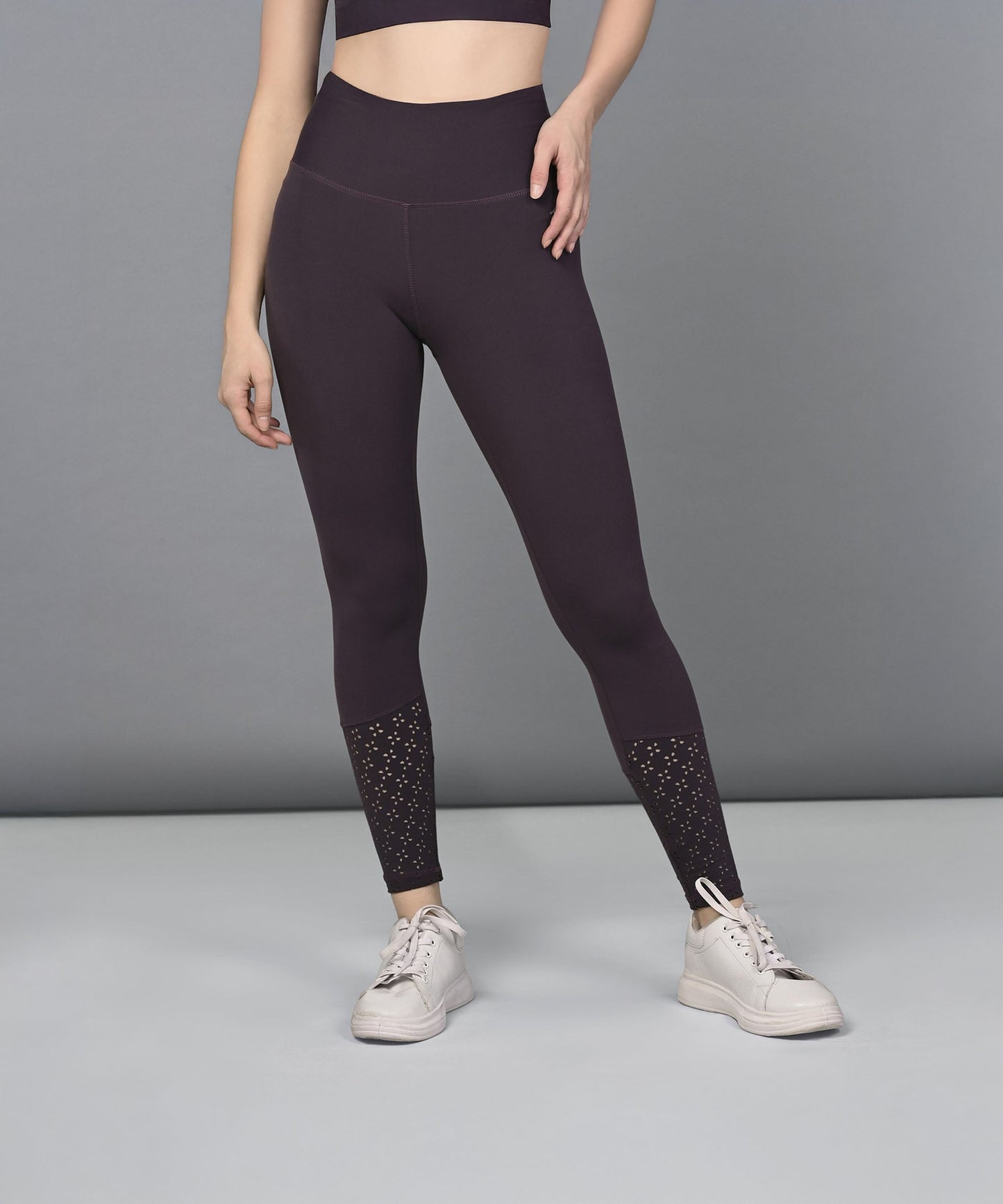 Trendy women's leggings in dark purple with stylish detailing at the ankles for active wear