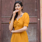 Model wearing a trendy yellow slit midi dress with puff sleeves and a flattering neckline