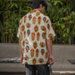Tribal print yellow oversize shirt featuring colorful masks, perfect for casual or summer wear.