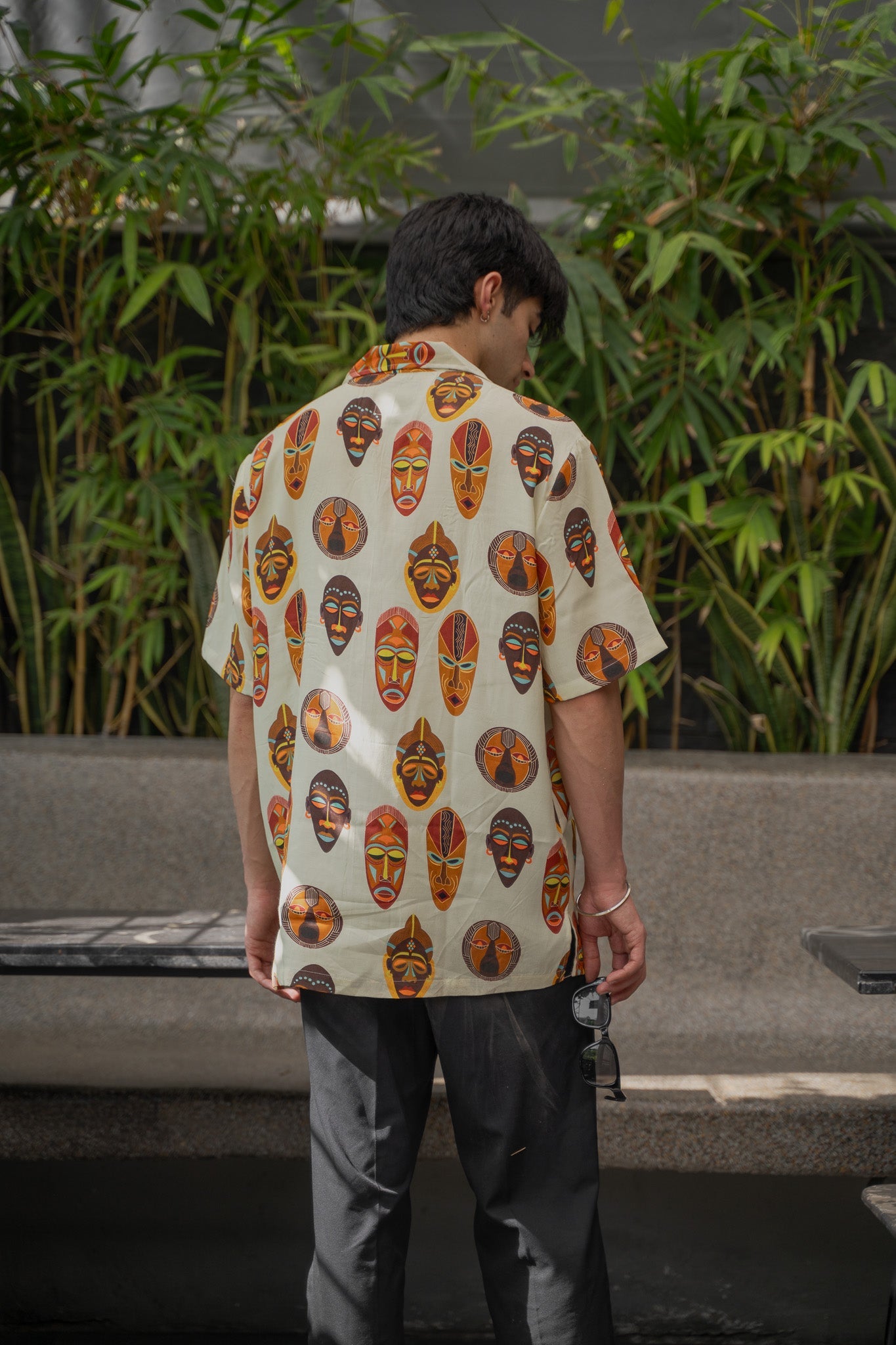 Tribal print yellow oversize shirt featuring colorful masks, perfect for casual or summer wear.