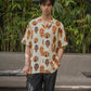 Tribal print yellow oversize shirt with unique mask designs for a bold summer look
