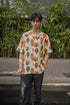 Tribal print yellow oversize shirt with unique mask designs for a bold summer look