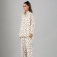 Model wearing Stylera two piece outfit polka dots cream button down long sleeve top and wide leg pants