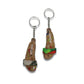 Unique accessory keychain featuring miniature shoe designs with colorful straps and cork material