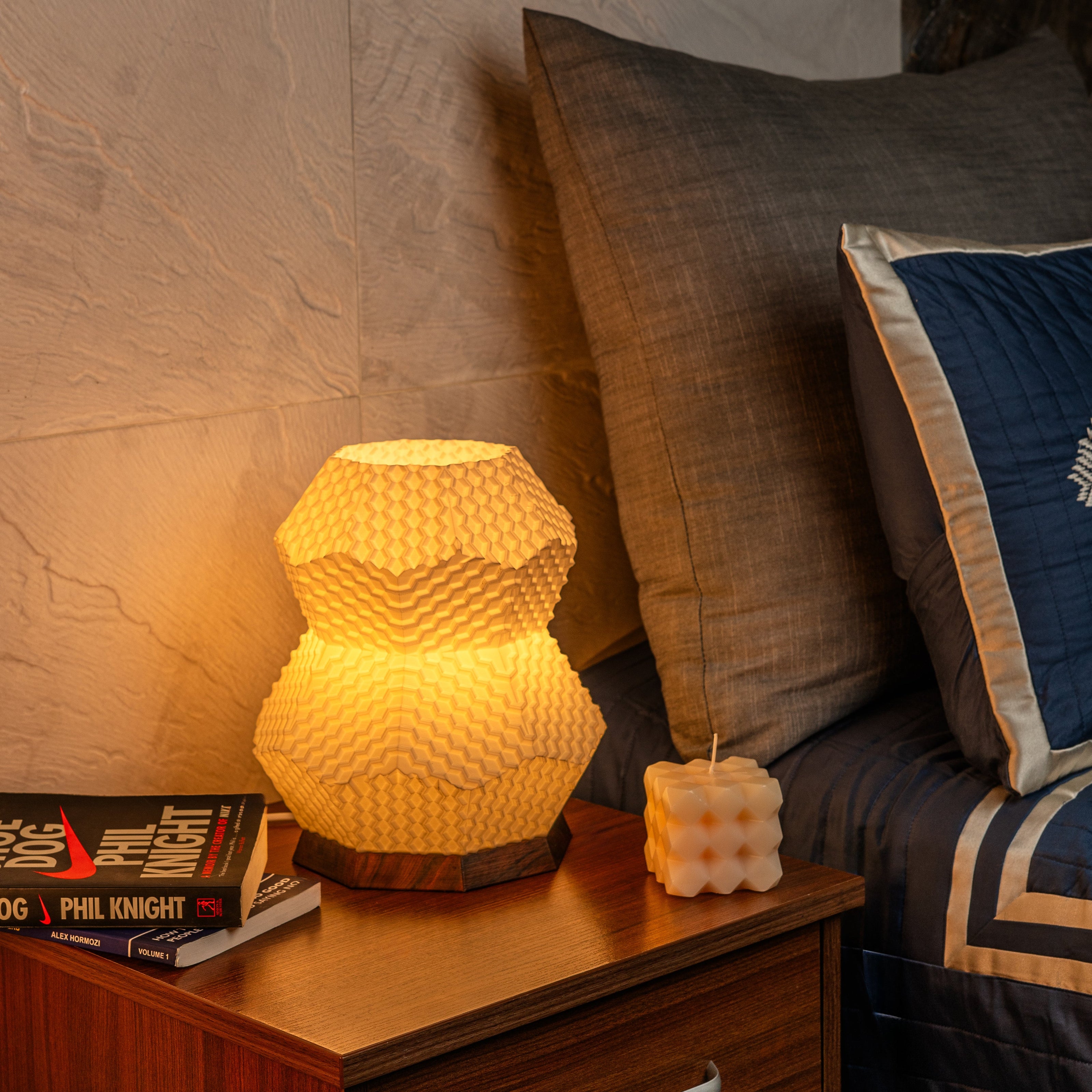 Sozori unique bedroom table lamp with a geometric design on a wooden nightstand beside a cozy bed