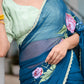 Unique blue saree for special occasions featuring floral design and intricate borders