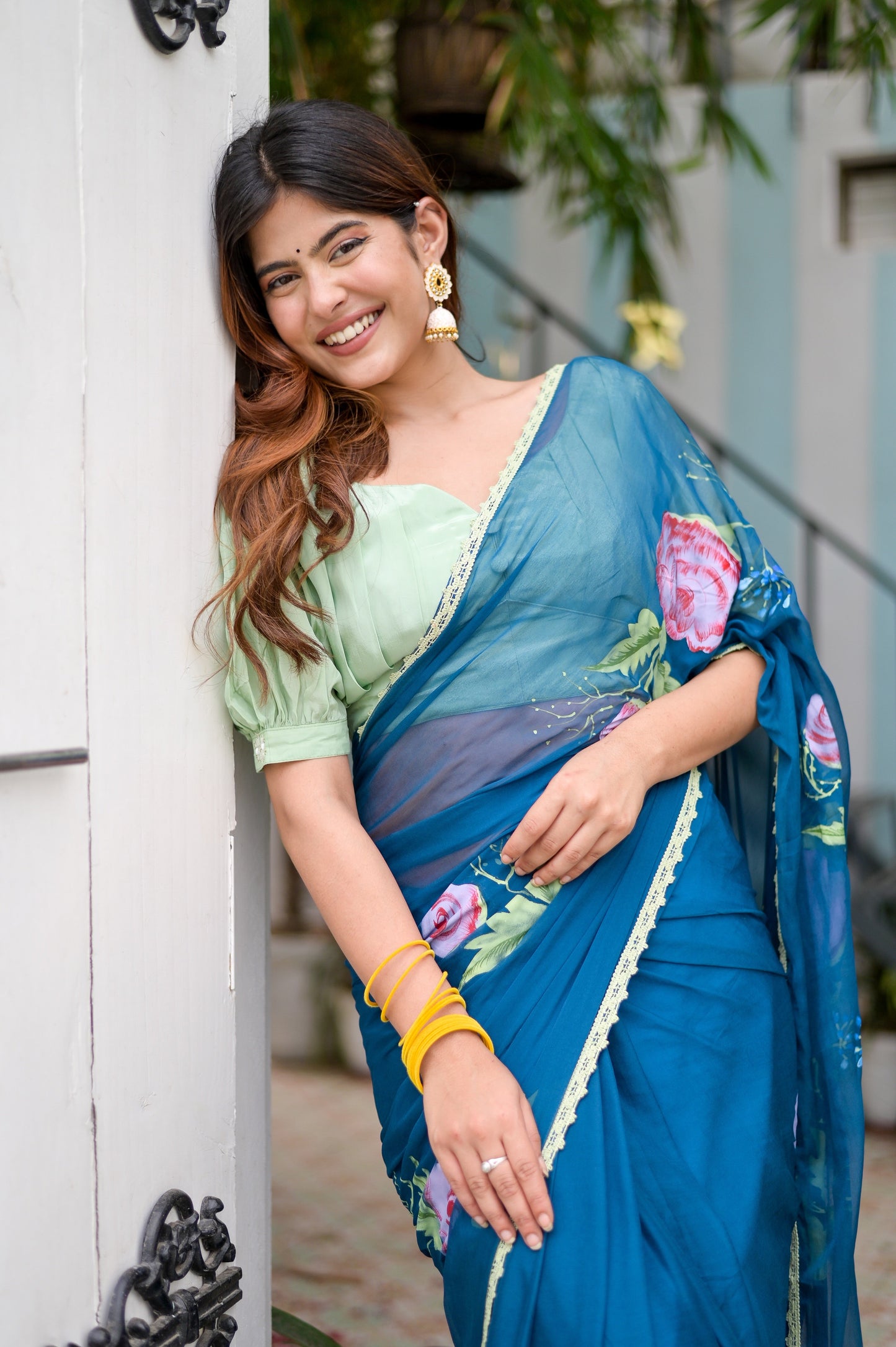 Model wearing a unique blue saree for special occasions, featuring floral designs and matching blouse