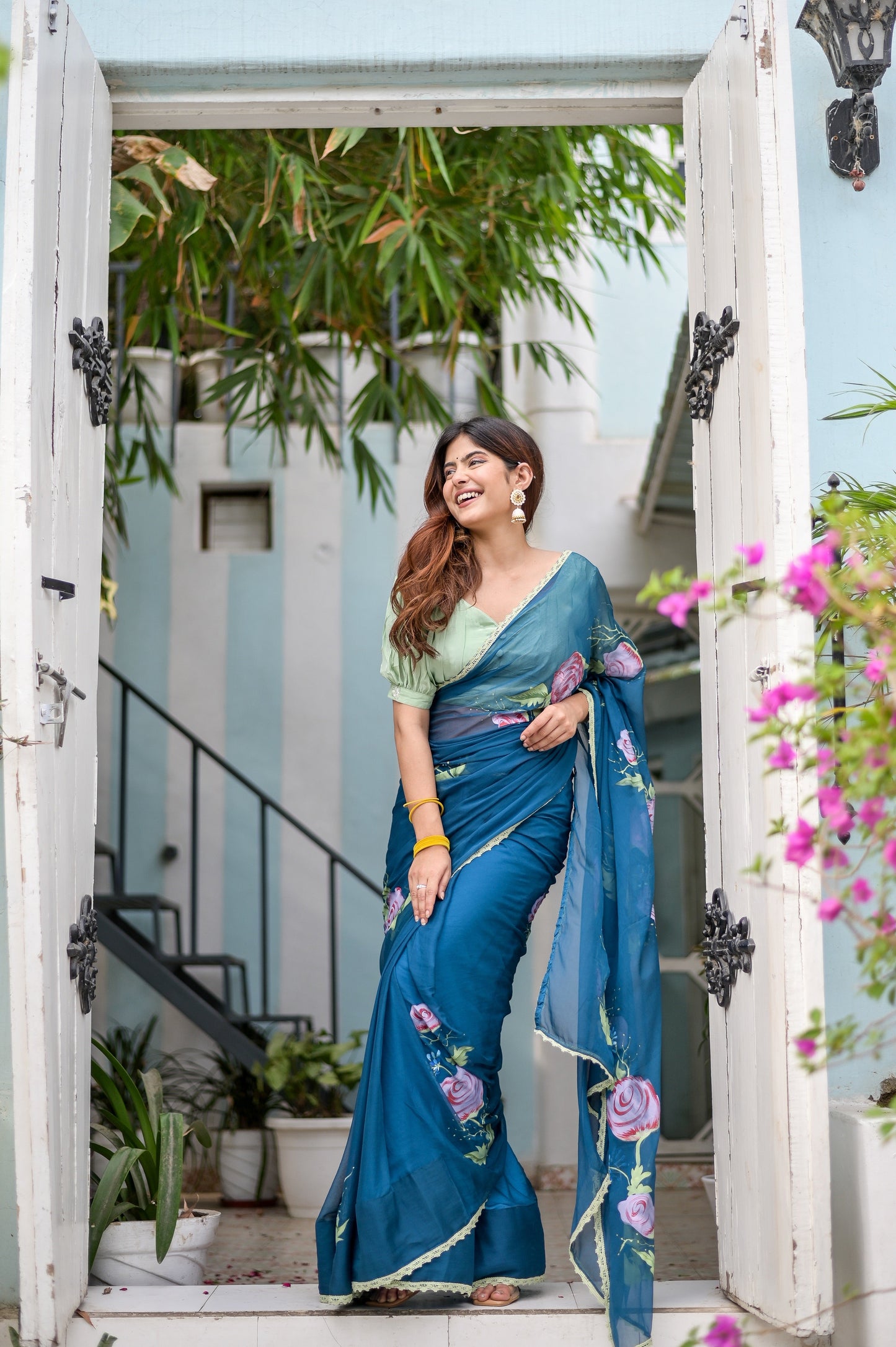 Elegant model in a unique blue saree for special occasions, featuring floral embroidery and a matching blouse.