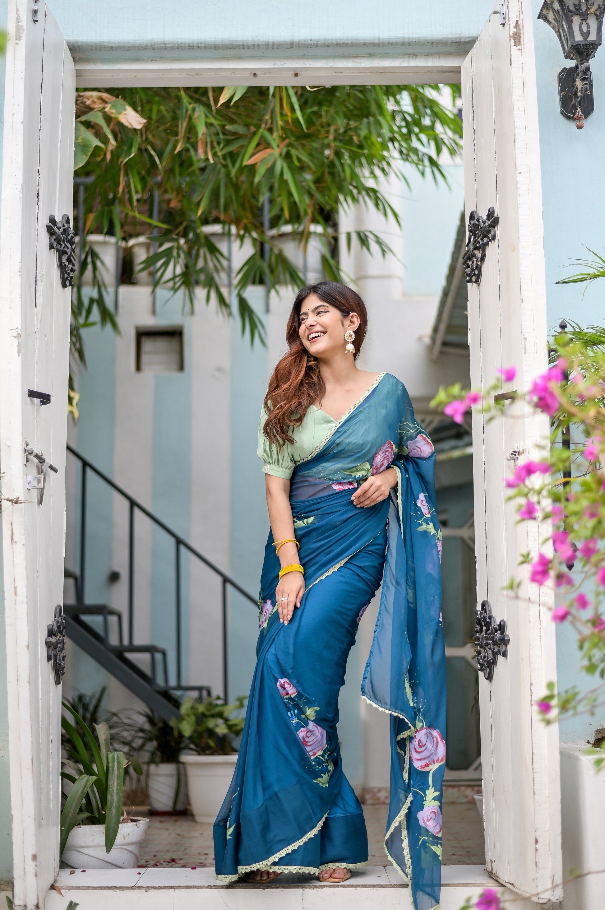 Elegant model in a unique blue saree for special occasions, featuring floral embroidery and a matching blouse.