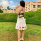 Woman wearing a unique casual dress for women with floral details in a scenic outdoor setting