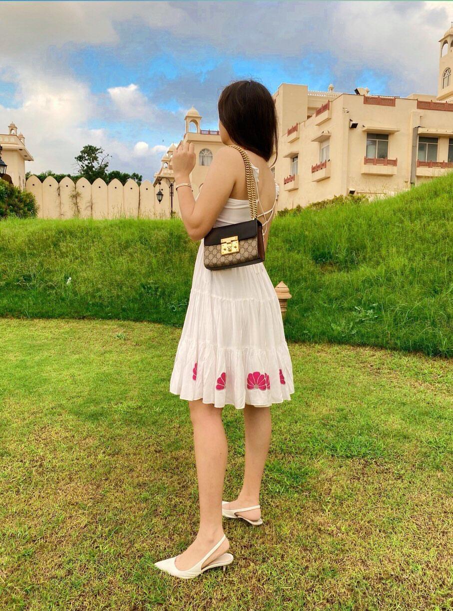 Woman wearing a unique casual dress for women with floral details in a scenic outdoor setting