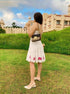 Woman wearing a unique casual dress for women with floral details in a scenic outdoor setting