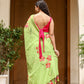 Stunning unique designer malmal saree in green with floral patterns, paired with a vibrant pink blouse