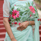 Unique designer organza saree in mint green with floral prints and elegant draping style