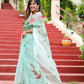 Beautiful woman modeling a unique designer organza saree with floral embroidery on a garden staircase
