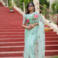 Unique designer organza saree in mint green with floral embroidery, perfect for special occasions