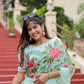 Elegant woman in a unique designer organza saree with floral patterns posing outdoors