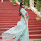 Stylish model wearing a unique designer organza saree with floral embroidery outdoors