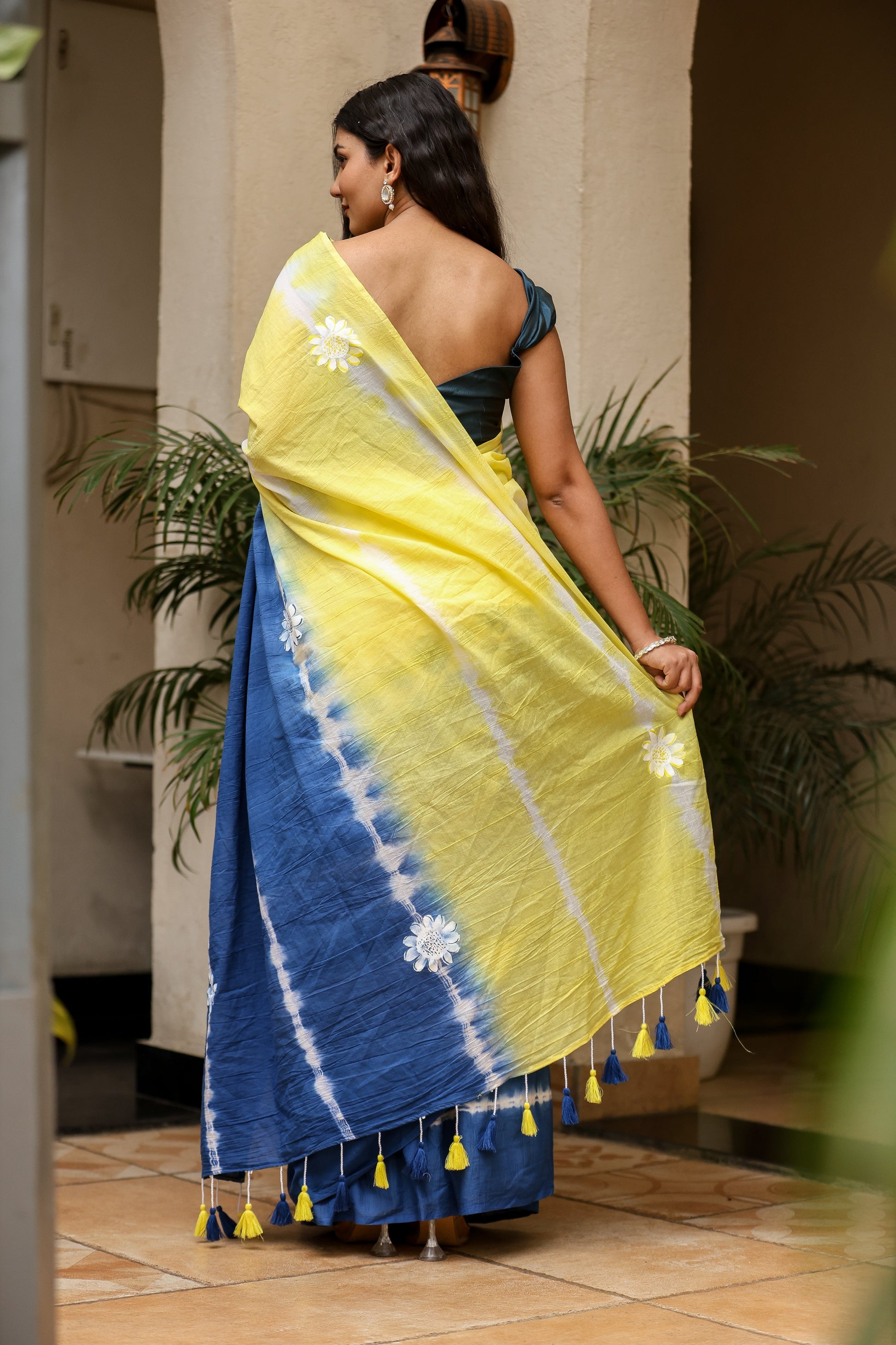 Unique designer saree for women in vibrant yellow and blue with floral accents and tassels