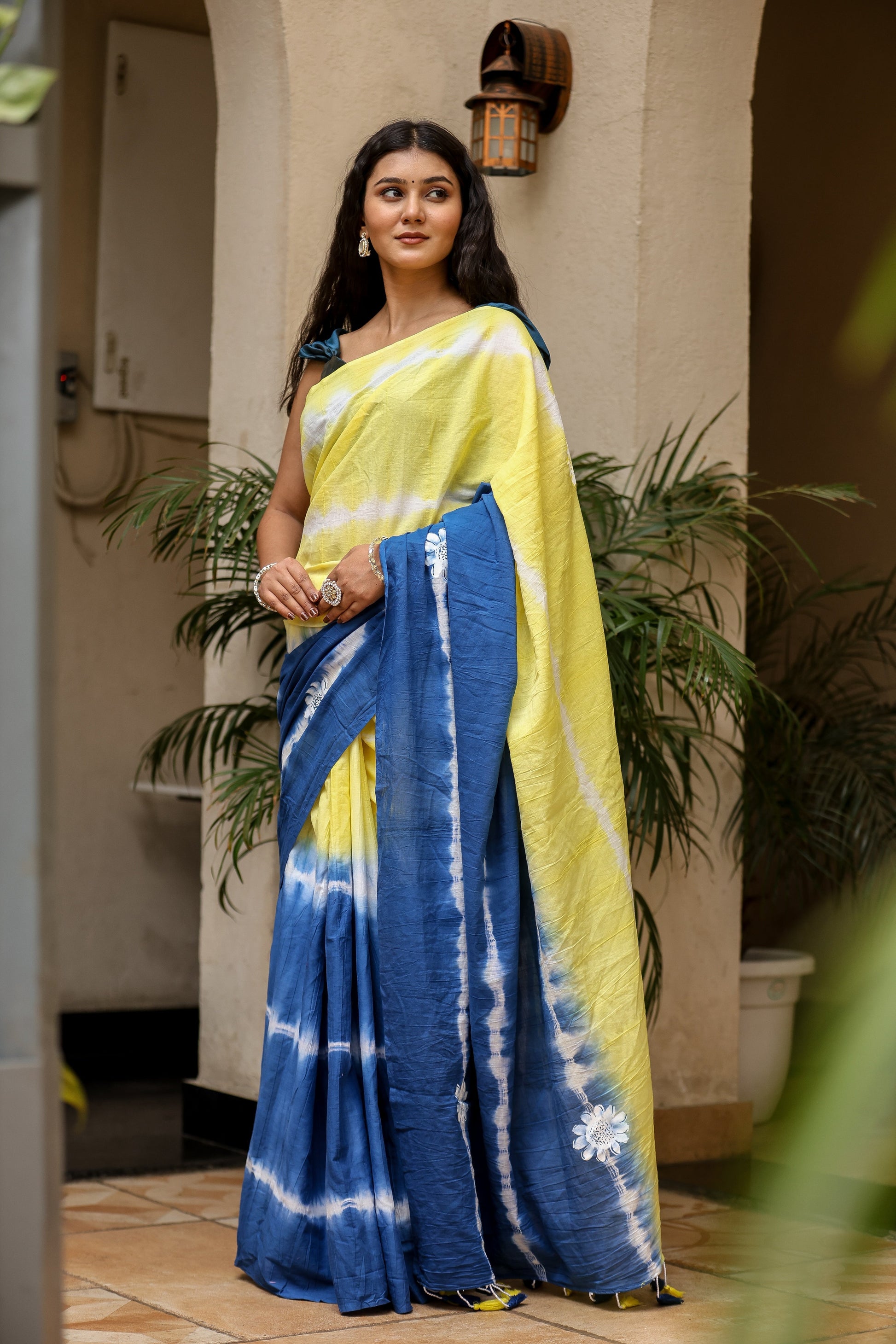 Unique designer saree for women in vibrant yellow and blue with tie-dye patterns and floral motifs