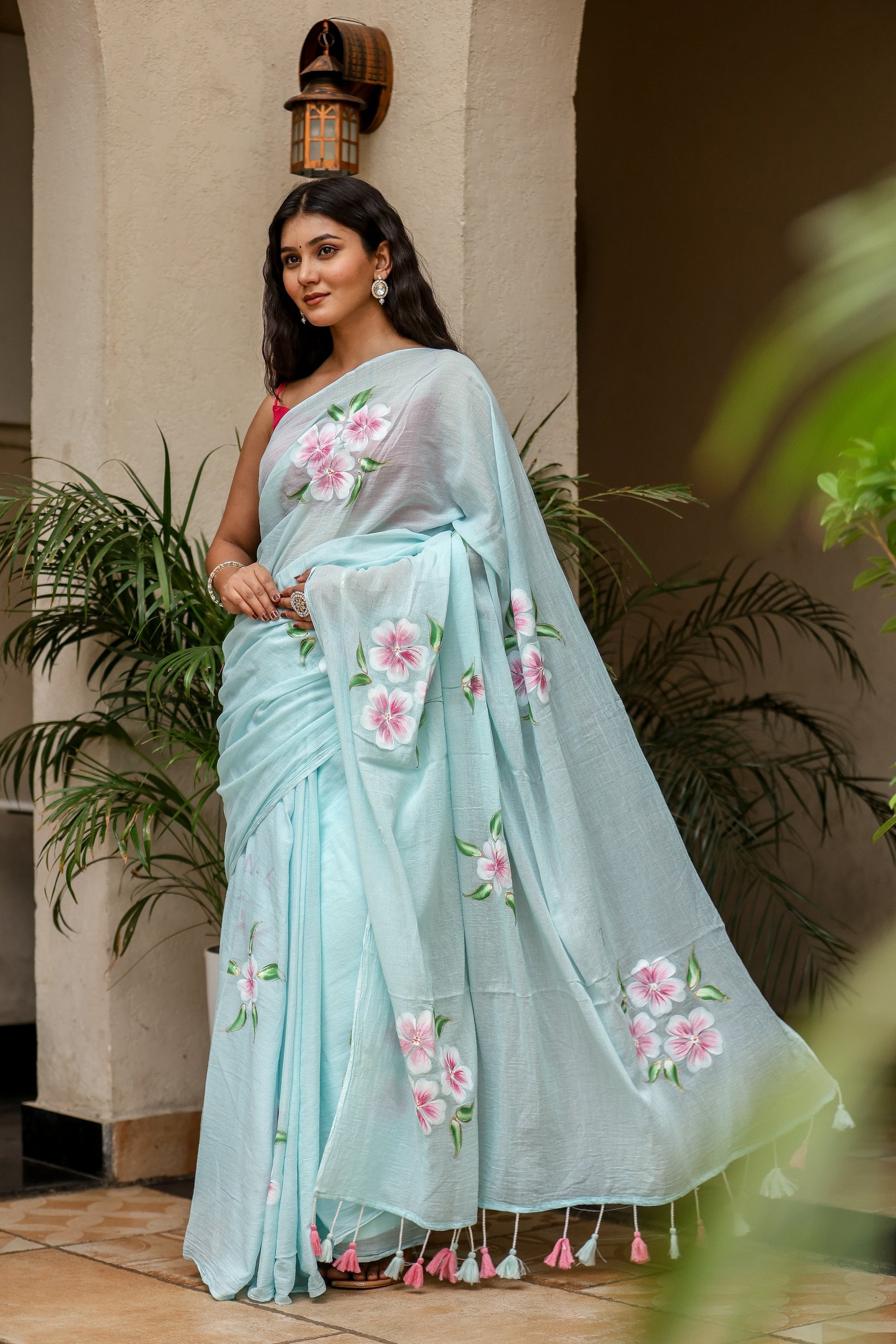 Elegant light blue unique designer sarees for parties with floral embroidery and tassel details