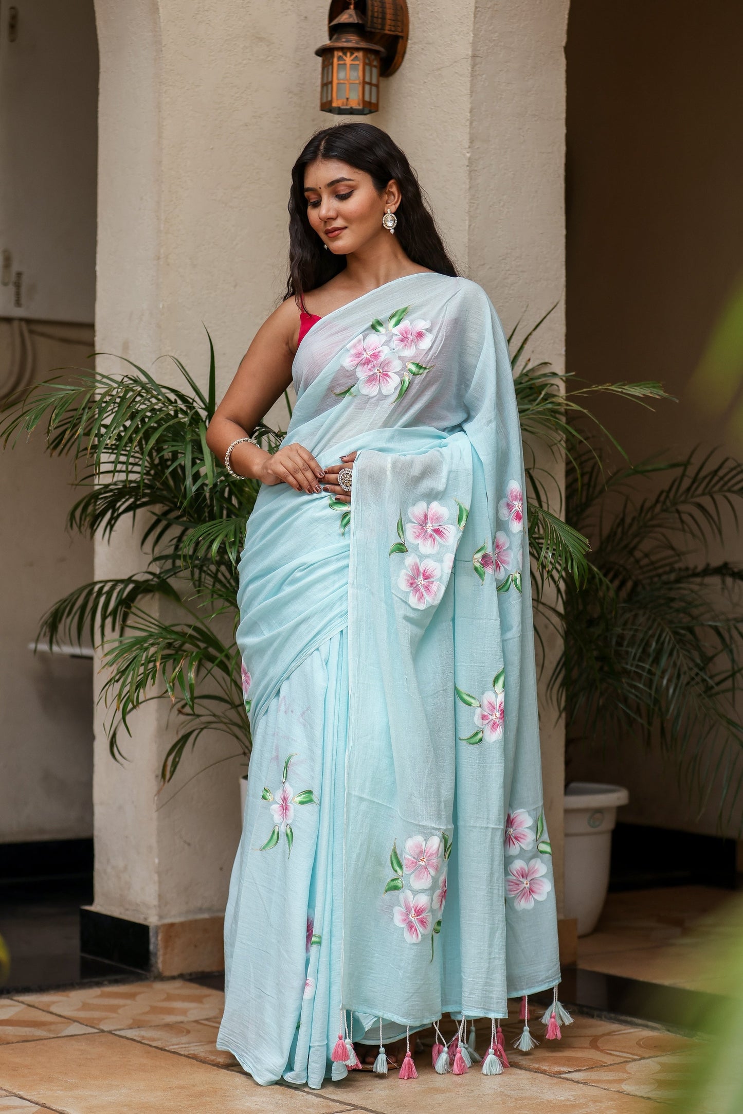 Stylera unique designer sarees for parties in light blue with floral embroidery and tassels