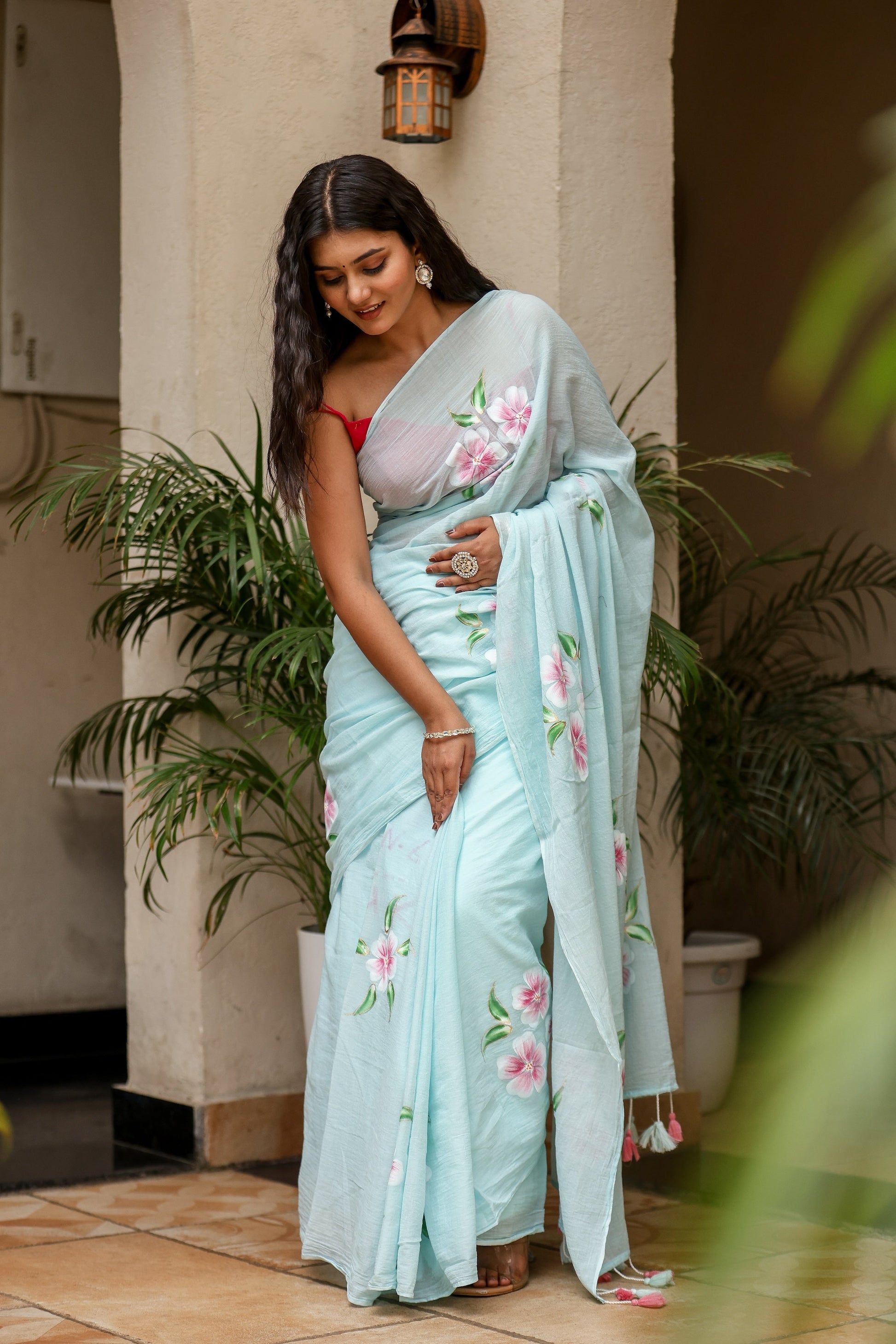 Elegant light blue unique designer sarees for parties featuring floral embroidery and a graceful drape