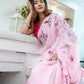 Elegant woman wearing a unique handpainted saree for weddings with floral embroidery in soft pink
