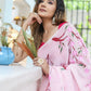 Elegant woman wearing a unique handpainted saree for weddings with floral designs in pink hues