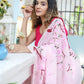 Elegant woman in a pink unique handpainted saree for weddings with floral designs draped gracefully