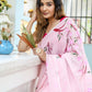 Elegant woman wearing a unique handpainted saree for weddings with floral designs, posing by a window