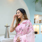 Elegant woman wearing a unique handpainted saree for weddings, adorned with floral embroidery.
