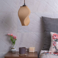 Sozori unique home decor lamps hanging above a stylish bedside table with flowers and a candle