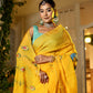 Unique Indian saree with embroidery in vibrant yellow worn by a model with traditional jewelry