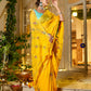 Stylera unique Indian saree with embroidery in vibrant yellow, styled elegantly outdoors