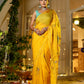 Elegant woman in a yellow saree with embroidery showcasing a unique Indian saree with embroidery