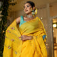 Elegant woman in yellow wearing a unique Indian saree with embroidery, showcasing vibrant peacock designs