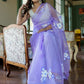 Model wearing a unique organza saree with artwork in lavender, showcasing floral designs and elegance