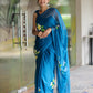 Model wearing a unique party wear saree in blue with floral embroidery, perfect for festive occasions