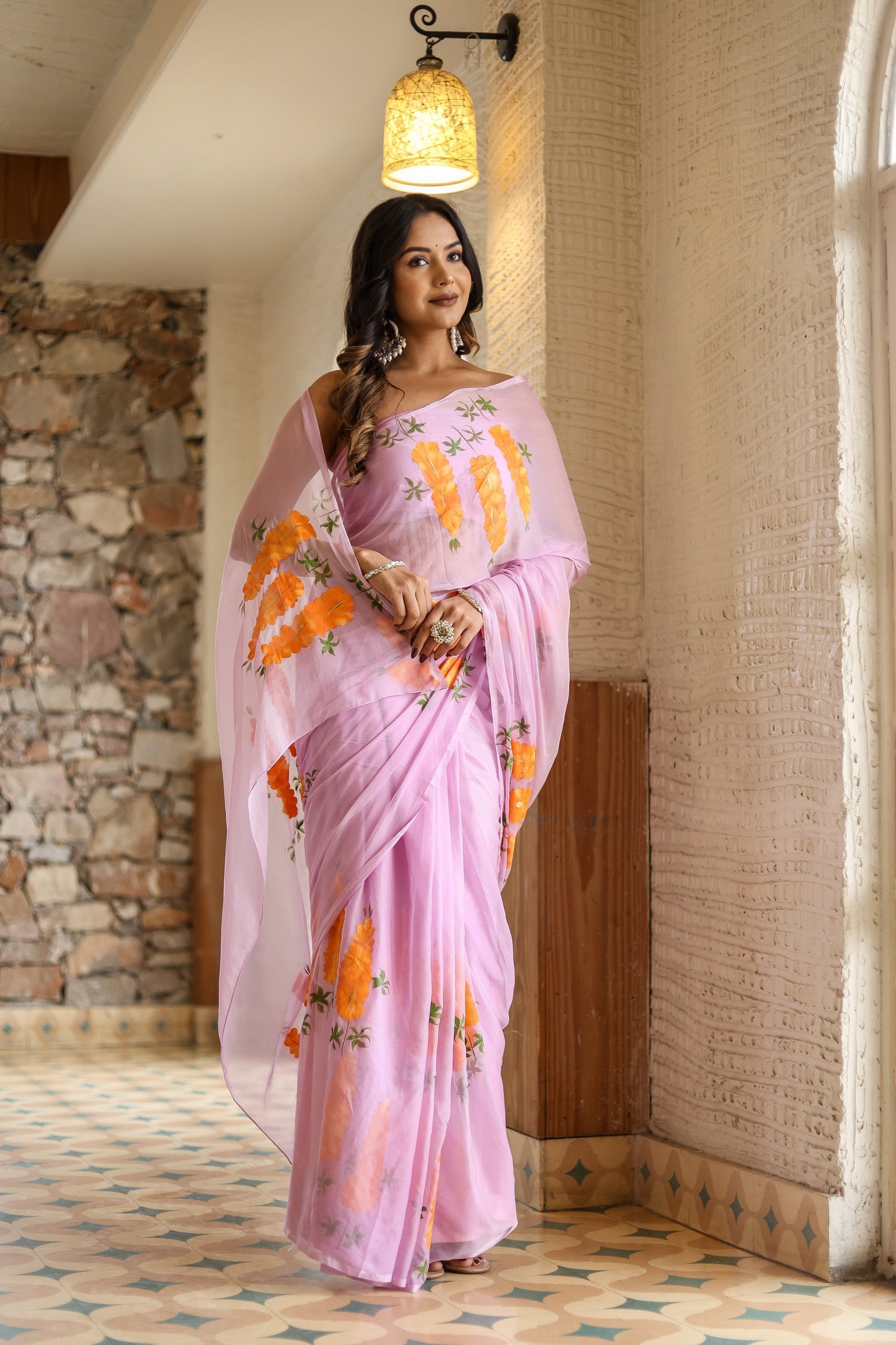 Unique party wear saree hand painted in soft pink with vibrant floral designs for elegant celebrations
