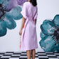 Stylera model back view lilac dress with belt and orange side panel white sneakers unique print relaxed fit dress