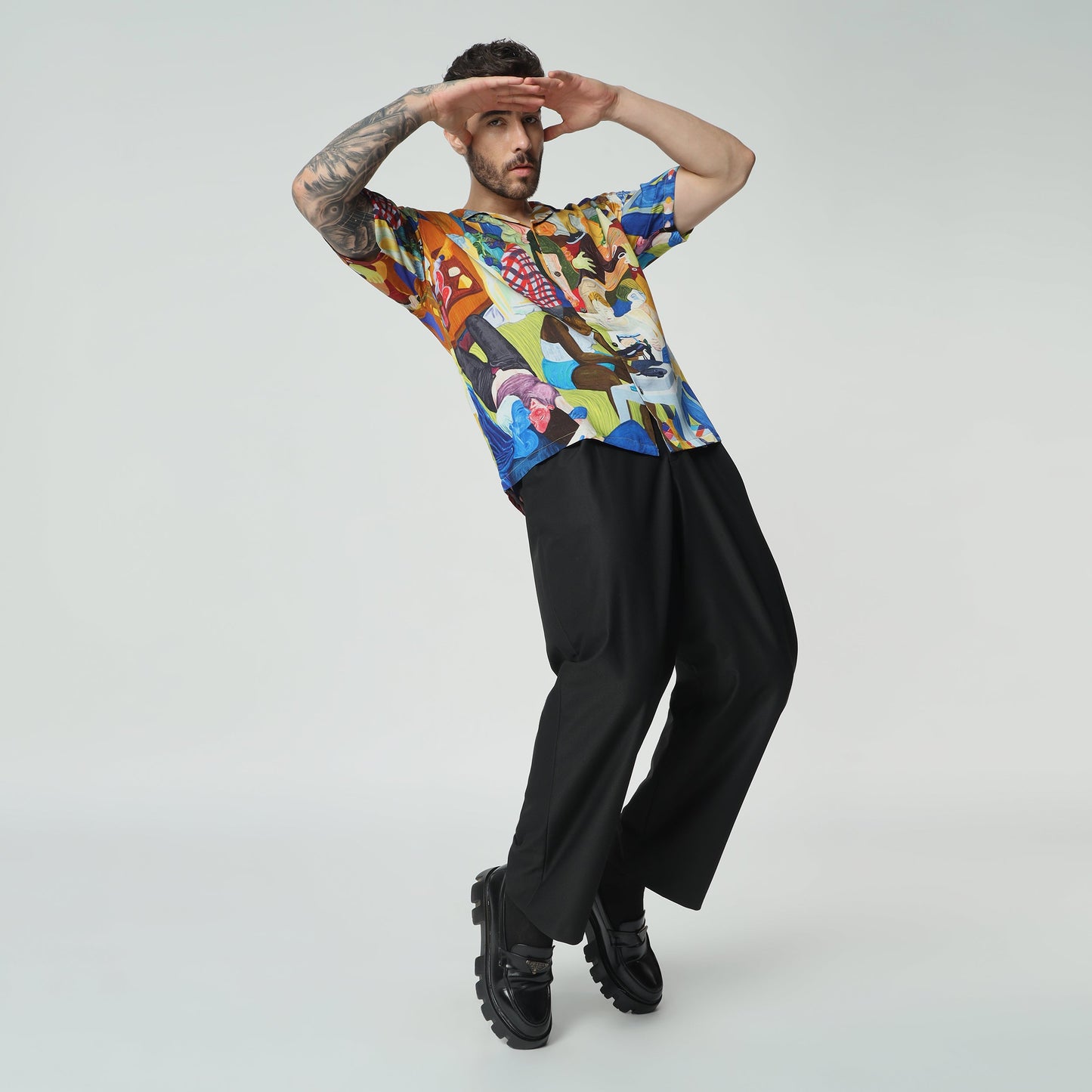 Stylera unique short sleeve fashion shirt featuring a vibrant, artistic design on a model striking a playful pose