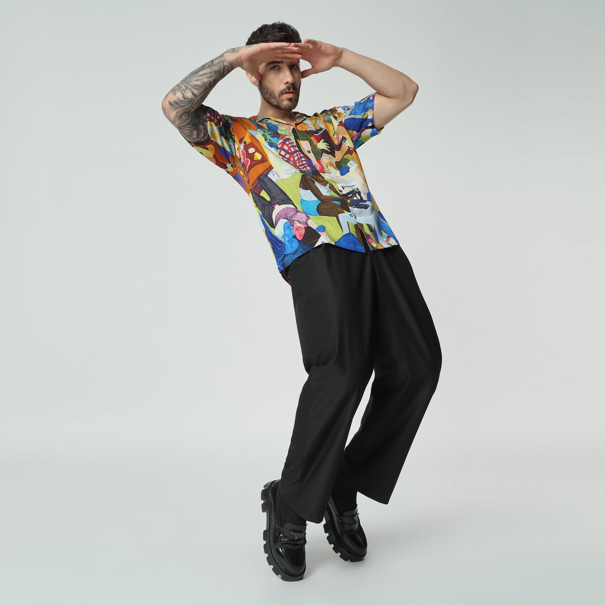 Stylera unique short sleeve fashion shirt featuring a vibrant, artistic design on a model striking a playful pose