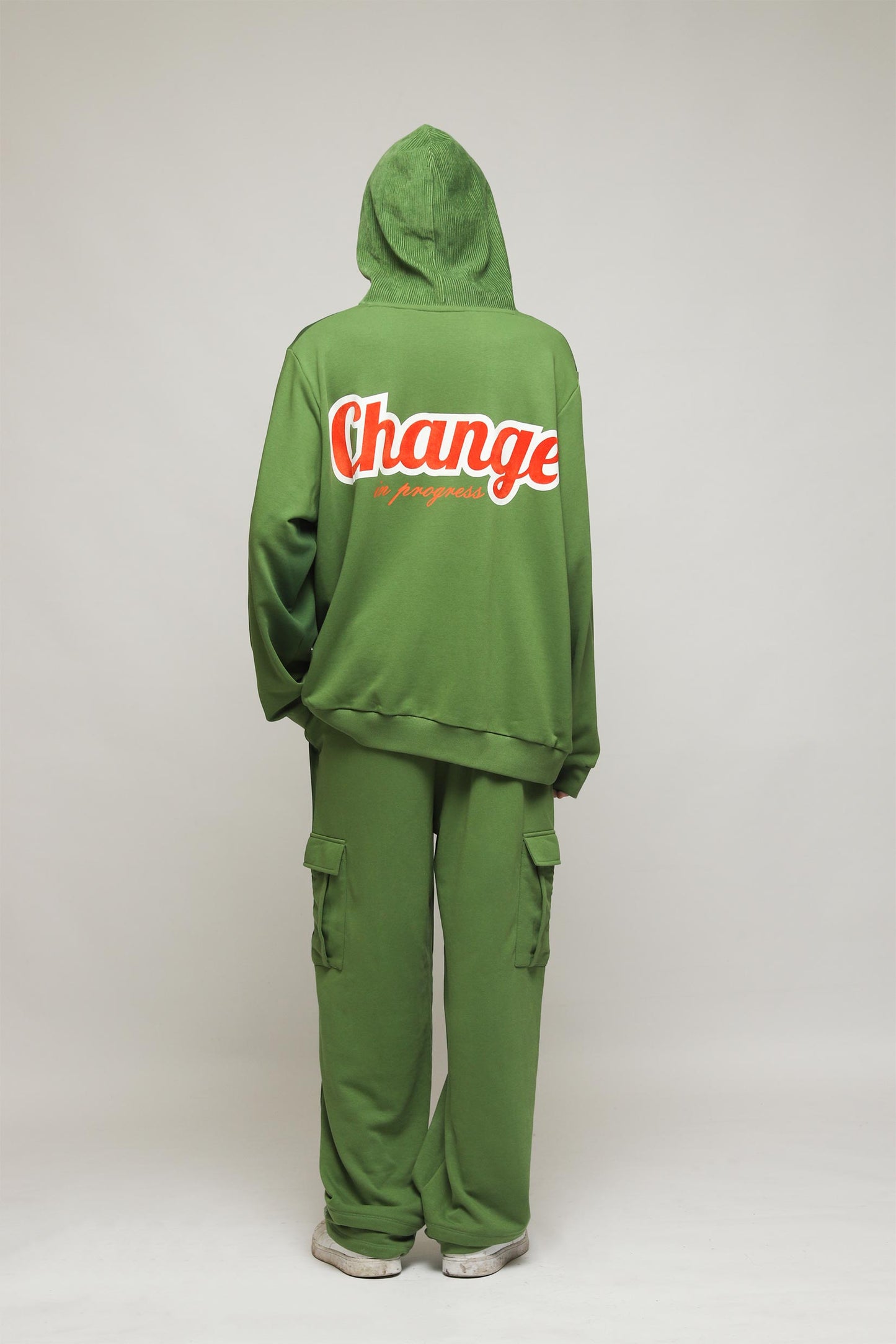 Stylera green oversized hoodie back view with red white Change print paired with cargo pants unique streetwear hoodie