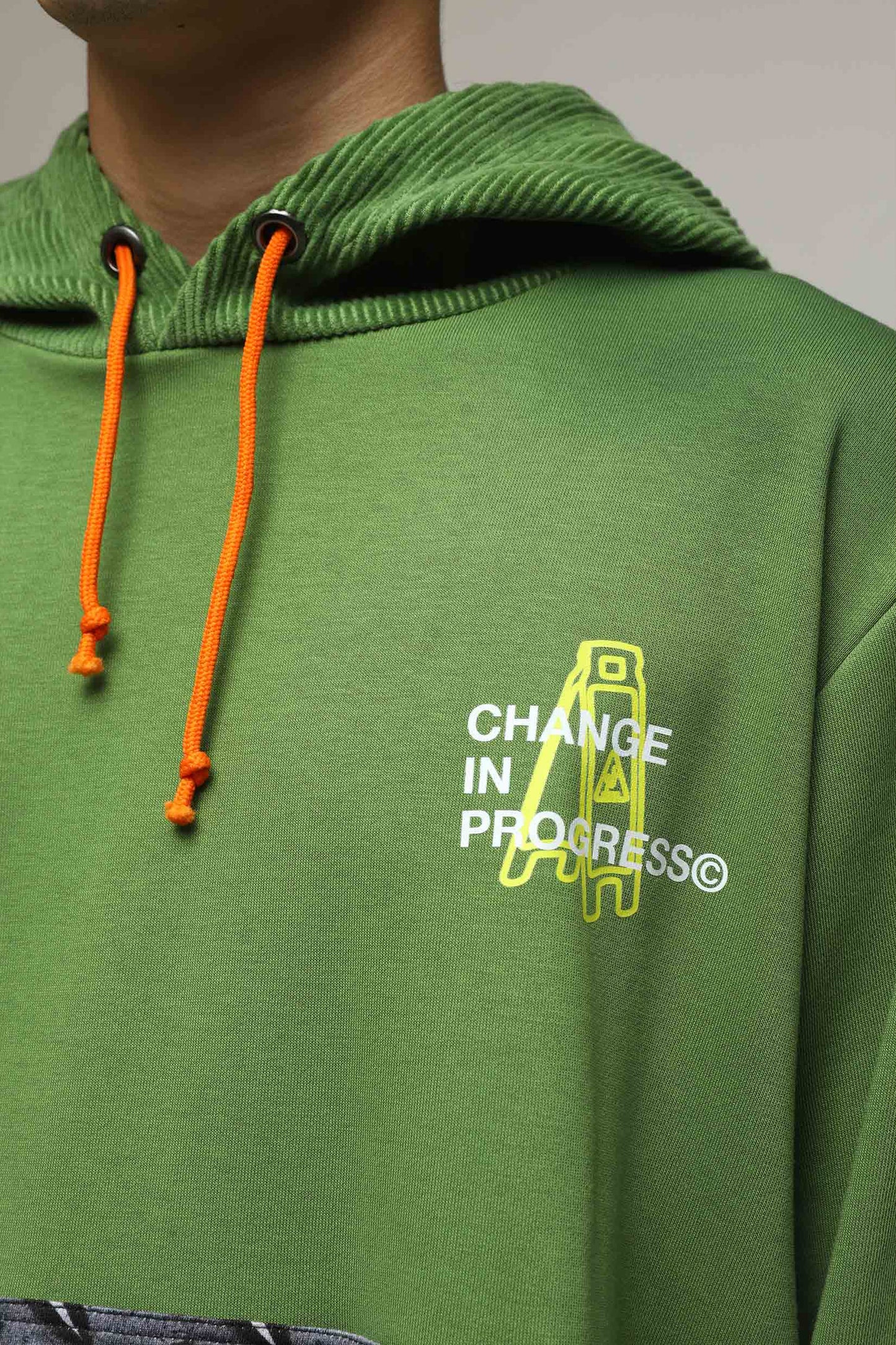 Stylera green hoodie with ribbed hood, orange drawstrings and Change in Progress ladder graphic unique streetwear hoodie